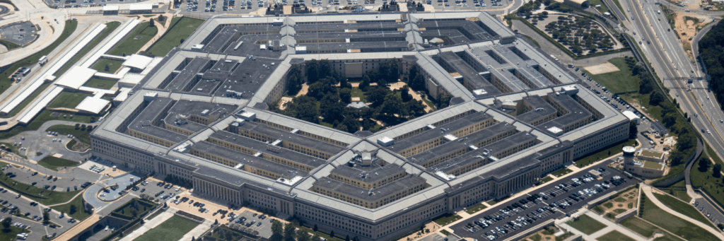 Aerial view of the Pentagon complex, the official headquarters of the department of defense, with surrounding roads, parking and greenery.