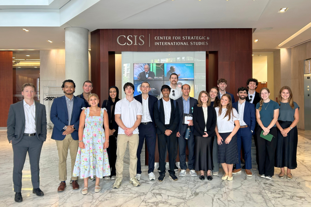 national security interns from NSPC programs pose for a group photo in the marble lobby of CSIS