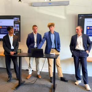 A group of national security policy center interns present their research to an audience of NSDPI staff and national security professionals