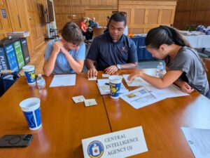 Three students work together at a table as part of a crisis simulation